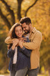 © New Africa - Beautiful young couple hugging in park on autumn day