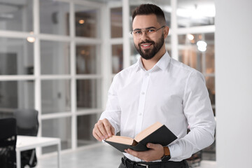 Poster - Portrait of smiling man with book in office, space for text. Lawyer, businessman, accountant or manager