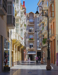 Wall Mural - Romantic backstreet, side street and alleys in historic old town of Cartagena, Spain with historic Spanish style architecture facades, a landmark sightseeing tourist spot in downtown