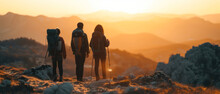 Family Adventure With Backpacks Hiking In The Mountains At Sunset