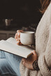 woman with book and cup of coffee