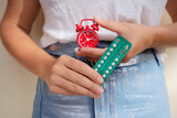 Fototapeta Storczyk - woman holding 21 day oral contraceptive pills, birth control and pregnancy planning