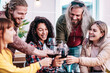 Happy men and women having fun drinking out at wine farm garden - Food and beverage life style concept on mixed age friends enjoying time together at home patio - Young people toast with glasses