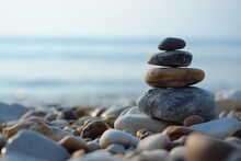A Mesmerizing Arrangement Of Rocks Forms An Ephemeral Sculpture On A Picturesque Beach.