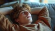 © carballo - young teenager relaxed lying on the sofa