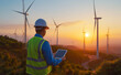 Wind energy engineer Industrial workers tablet sunset, teamwork in wind resource assessment, teamwork in technology deployment, teamwork in energy transition, concept Wind energy green power