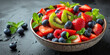 Fresh fruit salad with strawberries, blueberries and kiwi in a bowl.