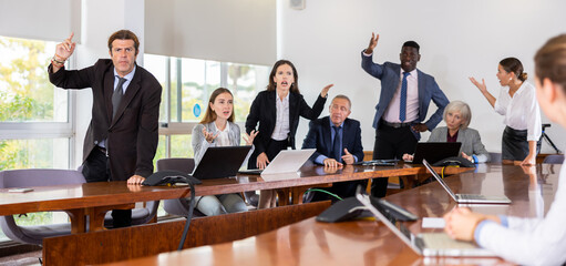 Agitated multiethnic business coworkers arguing at corporate team briefing trying to blame each other for a failure