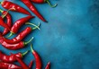 Minimal blue contrast background close up of red hot chilli peppers in a simple and clean composition allowing space for text