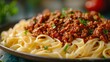 A savory plate of perfectly cooked al dente pasta smothered in rich bolognese sauce, topped with fresh parsley, transports you to the heart of italy with every bite