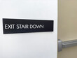 Stair down sign on a white wall