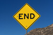 © Tom - Yellow And Black End Road Sign With Blue Sky And Rocky Hillside Behind