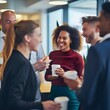 © Hasanul - Happy business people taking a coffee break in a modern office environment, showcasing teamwork and relaxation during work.