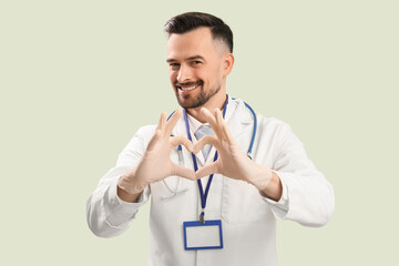 Sticker - Male doctor making heart with his hands on green background