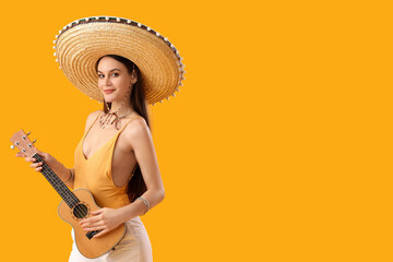 Canvas Print - Beautiful woman in sombrero hat and with guitar on yellow background