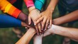 © Marco - group of young people putting hands together teamwork of different ethnicities and religions in a day park