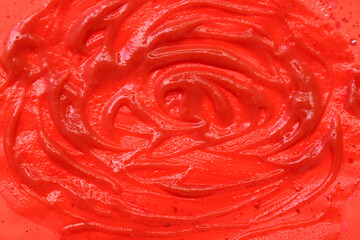 Wall Mural - Closeup view of tomato sauce smears on red background