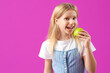 © Pixel-Shot - Happy little girl with healthy teeth and fresh apple on purple background