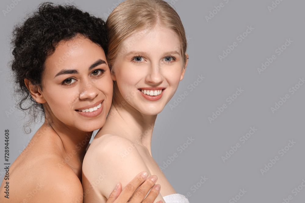 Beautiful women on grey background, closeup