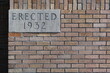 Erected 1932 placard on government building.