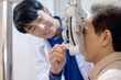 Optometrist uses ophthalmological diagnostic equipment to test the vision of an elderly man, diagnostic ophthalmology equipment, selective focus