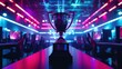 The esports winner trophy standing on the stage in the middle of the arena of the computer video game championship. Two rows of PCs for competing teams. Stylish neon lights with a cool design