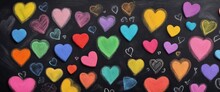 Creative Expression Of Love Using Colorful Chalk Hearts On A Blackboard. 