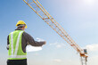 © Kwangmoozaa - construction engineer worker in protective helmet and blueprints paper on hand at building site background
