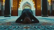 person is seen kneeling down on an ornate and colorful rug with their hands together and head bowed in a posture of devotion or prayer