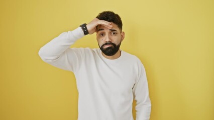 Sticker - Stressed young man stands in trouble, worried about crisis problem, hand on his forehead against isolated yellow background