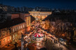 Budapest, Hungary - Aerial view of the Christmas market and carousel on Szentlelek square, Obuda at dusk. Decorative illuminated shops, festive decoration and Christmas signs on the streets of Buda