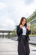 © StockPhotoRepublic - Young woman cheer for success while using phone outdoor