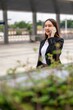 © StockPhotoRepublic - Young asian businesswoman using phone outdoor