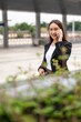 © StockPhotoRepublic - Young asian businesswoman using phone outdoor