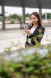 © StockPhotoRepublic - Young asian businesswoman using phone outdoor