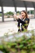 © StockPhotoRepublic - Young asian businesswoman using phone outdoor