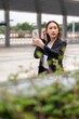 © StockPhotoRepublic - Young asian businesswoman using phone outdoor