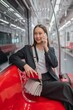 © StockPhotoRepublic - Asian businesswoman talking on phone while on the way traveling to the airport in a metro skytrain