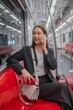 © StockPhotoRepublic - Asian businesswoman talking on phone while on the way traveling to the airport in a metro skytrain