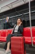 © StockPhotoRepublic - Young Asian Businesswoman Using Phone On The Public Skytrain