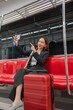 © StockPhotoRepublic - Young Asian Businesswoman Using Phone On The Public Skytrain