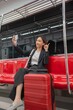 © StockPhotoRepublic - Young Asian Businesswoman Using Phone On The Public Skytrain