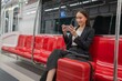 © StockPhotoRepublic - Young Asian Businesswoman Using Phone On The Public Skytrain