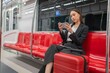 © StockPhotoRepublic - Young Asian Businesswoman Using Phone On The Public Skytrain
