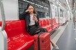 © StockPhotoRepublic - Young Asian Businesswoman Using Phone On The Public Skytrain
