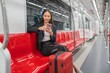 © StockPhotoRepublic - Young Asian Businesswoman Using Phone On The Public Skytrain