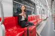 © StockPhotoRepublic - Young Asian Businesswoman Using Phone On The Public Skytrain