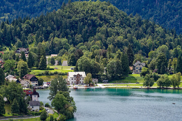 Wall Mural - Scenic view of lakeshore with promenade at Lake Bled on a cloudy summer day. Photo taken August 8th, 2023, Bled, Slovenia.