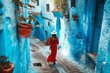 Young woman with red dress visiting the blue city Chefchaouen, Marocco - Happy tourist walking in Moroccan city street - Travel and vacation lifestyle, Generative AI