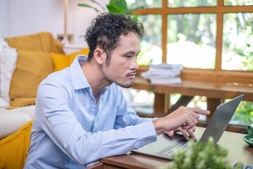 Wall Mural - Portrait male professional entrepreneur business man manager sitting indoor working laptop computer smiling, adult business man person looking happy cheerful confidence online internet occupation